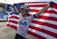 risten Faulkner revels in her triumph beneath the Eiffel Tower following her win in the Olympic Women’s Cycling Road Race in Paris, August 4, 2024 (AP Photo).