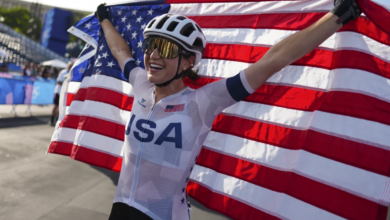 risten Faulkner revels in her triumph beneath the Eiffel Tower following her win in the Olympic Women’s Cycling Road Race in Paris, August 4, 2024 (AP Photo).