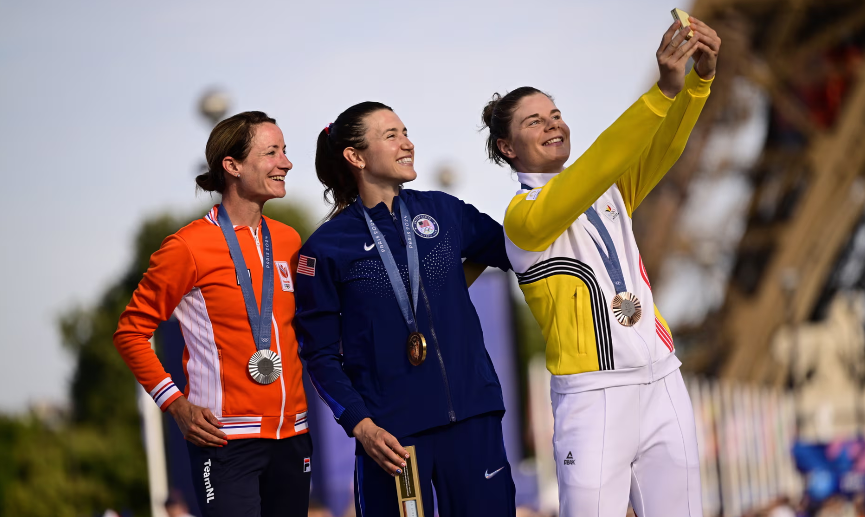 Gold medalist Kristen Faulkner is flanked by Marianne Vos, who secured the silver, and Lotte Kopecky of Belgium, the bronze medalist. Photo (REX/Shutterstock)