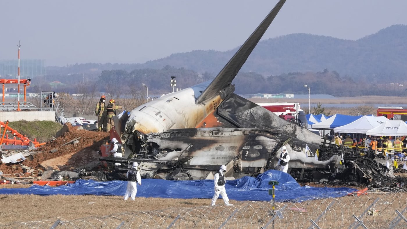 Firefighters and rescue team members respond to the wreckage of a passenger plane at Muan International Airport in Muan, South Korea, on Sunday, December 29, 2024. (AP Photo/Ahn Young-joon)