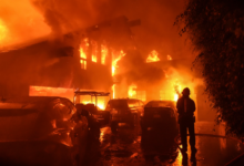 A firefighter directs a stream of water onto a burning home during the Franklin Fire in Malibu, California, on Tuesday. (Jae C. Hong/AP)