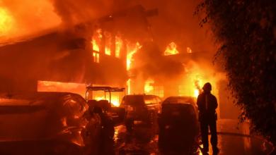 A firefighter directs a stream of water onto a burning home during the Franklin Fire in Malibu, California, on Tuesday. (Jae C. Hong/AP)