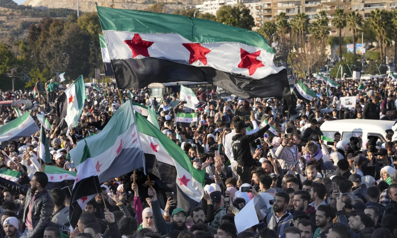 people celebrate after Friday prayers in Damascus, Syria, Friday, Dec. 13, 2024. (AP Photo/Omar Sanadiki)
