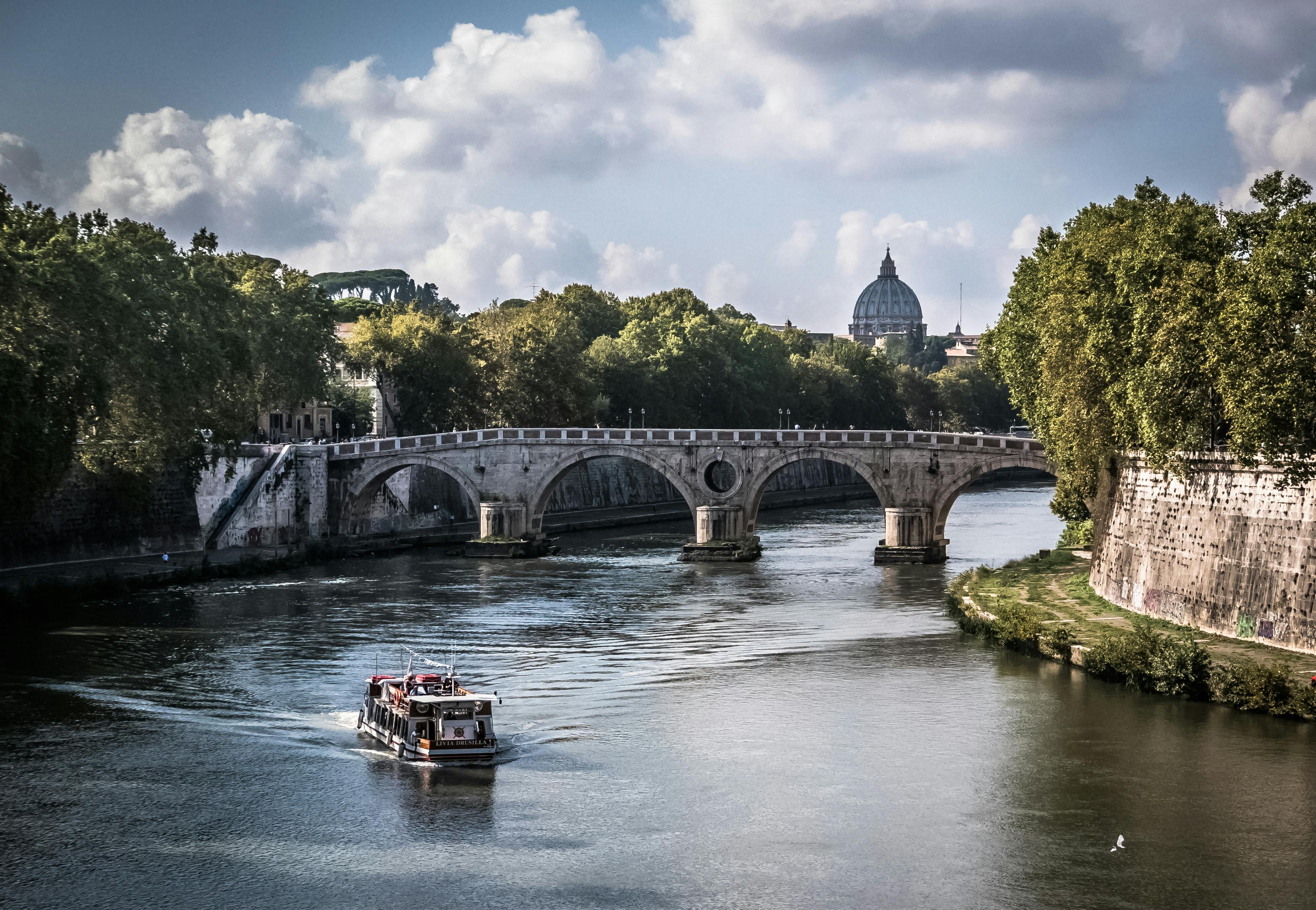 White Boat on Body of Water Crossing a Gray Concrete Bridge during Daytime, Roma, Lazio, Italy