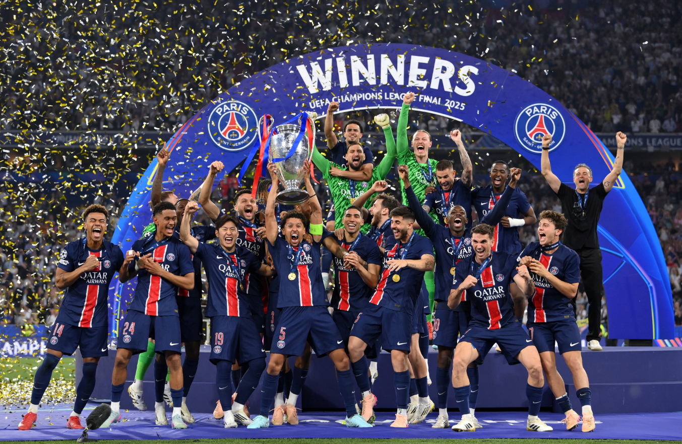 Marquinhos lifts the trophy, celebrating with teammates after Paris Saint-Germain’s Champions League win.