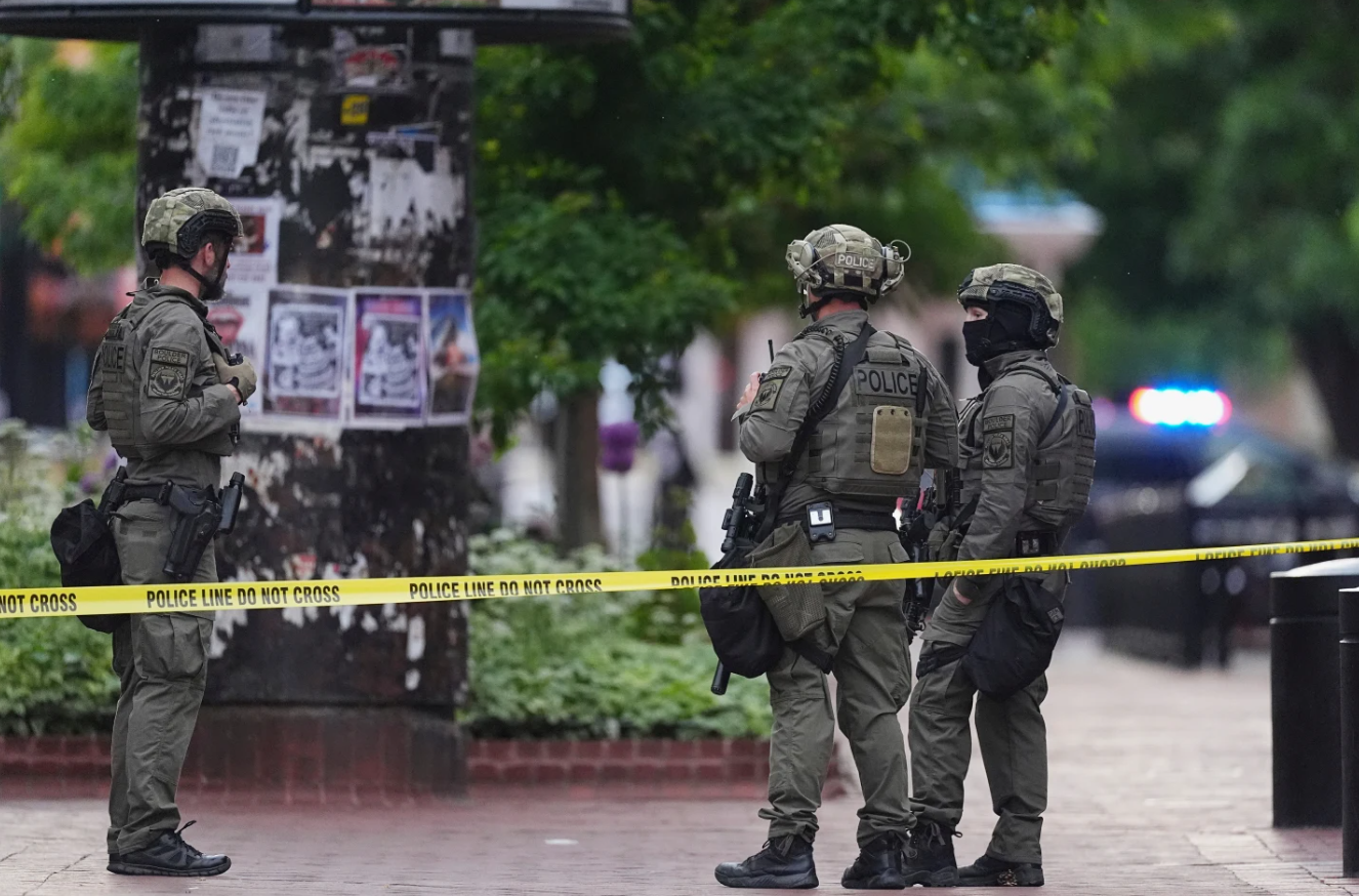 Law enforcement officers examine the scene after an attack at Pearl Street Mall in Boulder, Colorado, on June 1.