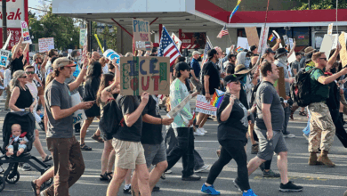 Demonstrators carry signs and chant while marching during a "No Kings" protest, Saturday, June 14, 2025, in Salt Lake City.